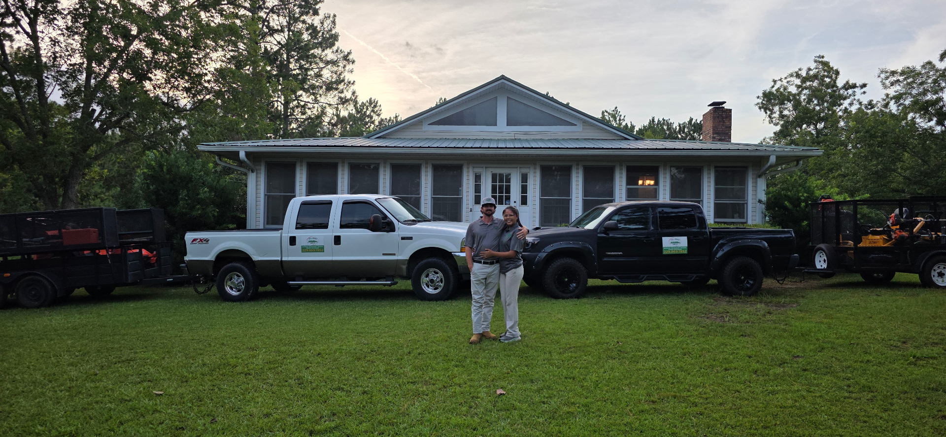 Tall Grass Lawn Co. crew and trucks in front of a client home